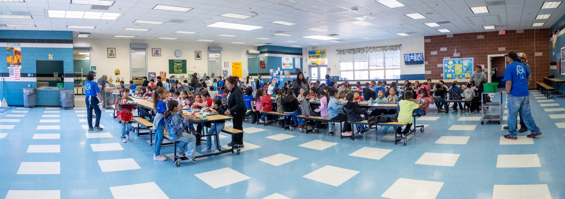 Cafeteria during a meal at the school bustling with students and staff.