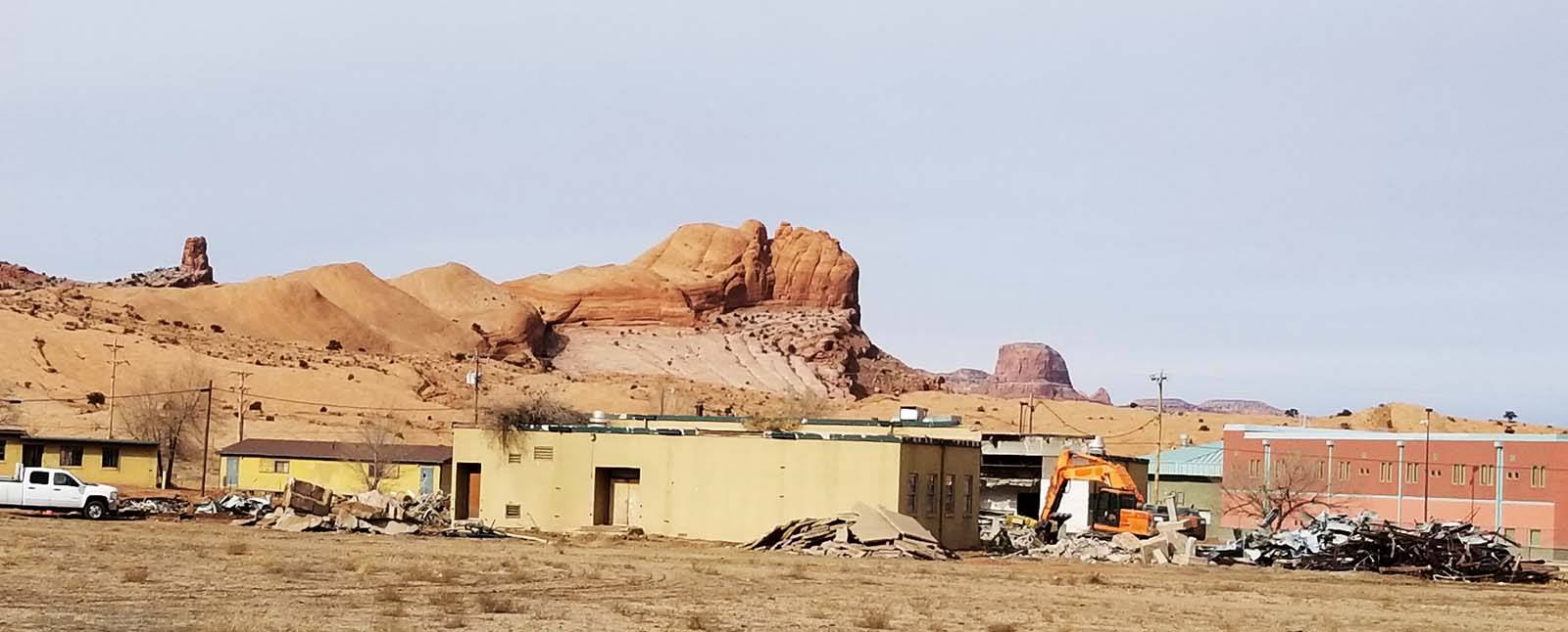 Old school building during demolition with beautiful background landscape.