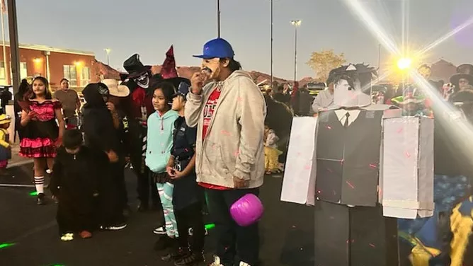 Parents and students dressed up for Halloween. 