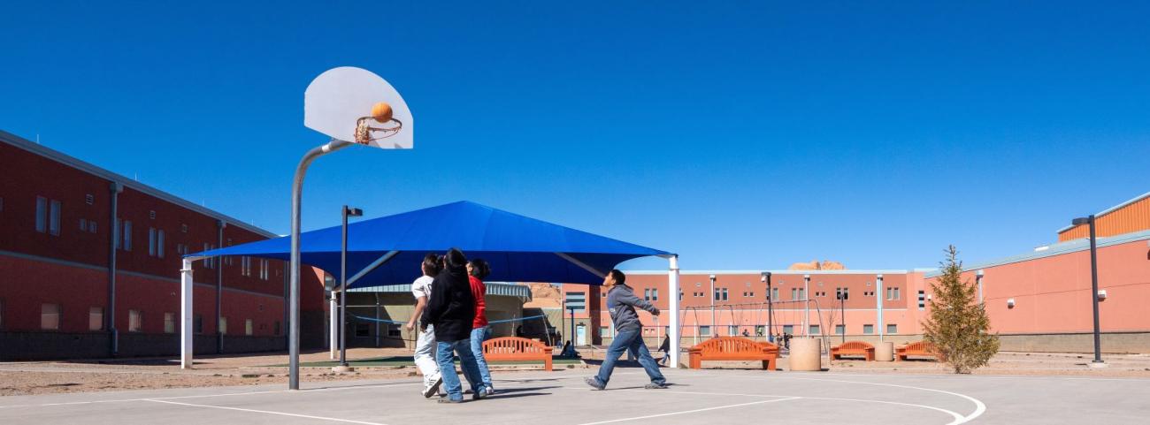 Several players are on a basketball court, actively playing and trying to score points in a game.